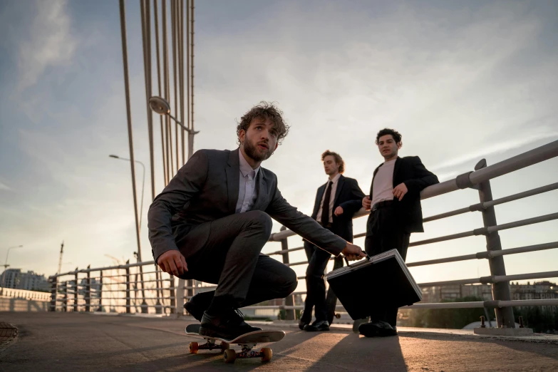 a group of men riding skateboards across a bridge, an album cover, by Luis Molinari, pexels contest winner, in a business suit, phosphorescent, standing on a desk, mid shot portrait