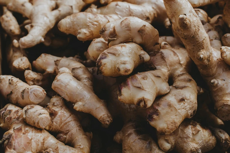 a pile of fresh gingers sitting on top of each other, unsplash, background image, high detail photo