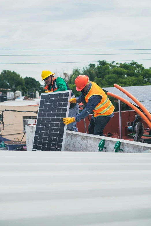 a couple of men standing on top of a roof, clean energy, bright construction materials, joel torres, press photos