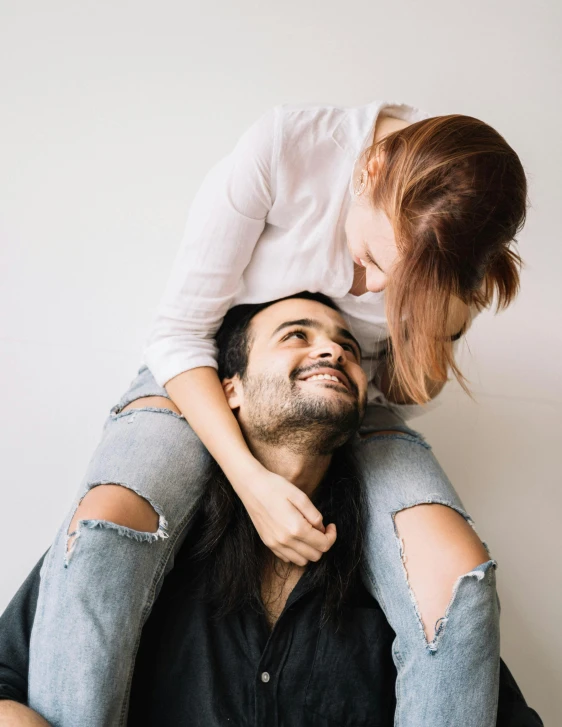 a man sitting on top of a woman's shoulders, trending on unsplash, smiling male, on a pale background, instagram photo, cuddly