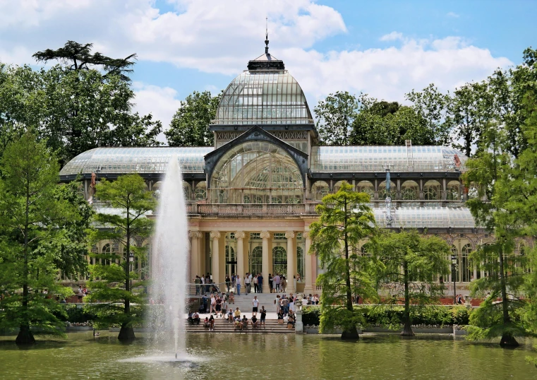 a large building with a fountain in front of it, inspired by Serafino De Tivoli, pexels contest winner, art nouveau, huge greenhouse, parks and lakes, paler. millions of glass-walled, las pozas