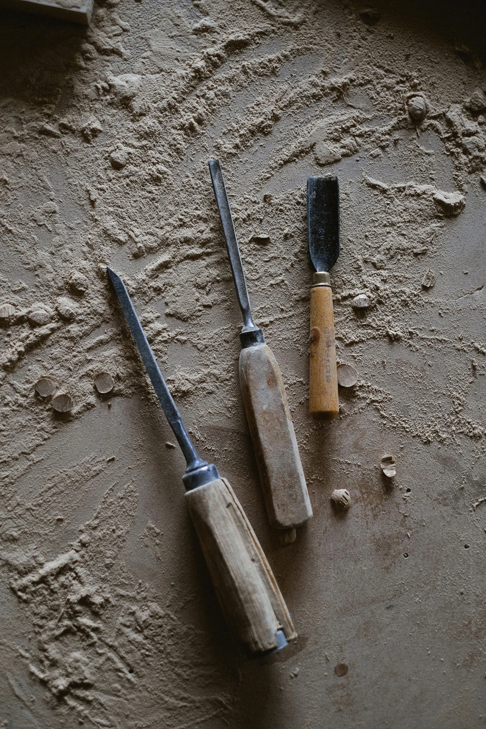 a couple of tools sitting on top of a table, hard clay, profile image, handheld, about