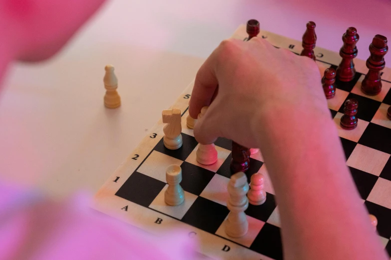 a close up of a person playing a game of chess, white and pink, photograph taken in 2 0 2 0, rectangle, fan favorite