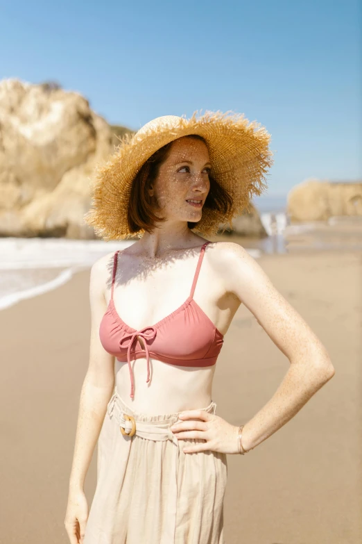 a woman standing on top of a sandy beach, a colorized photo, inspired by Rose O’Neill, pexels contest winner, renaissance, wearing straw hat, bare midriff, eleanor tomlinson, wearing a cute top