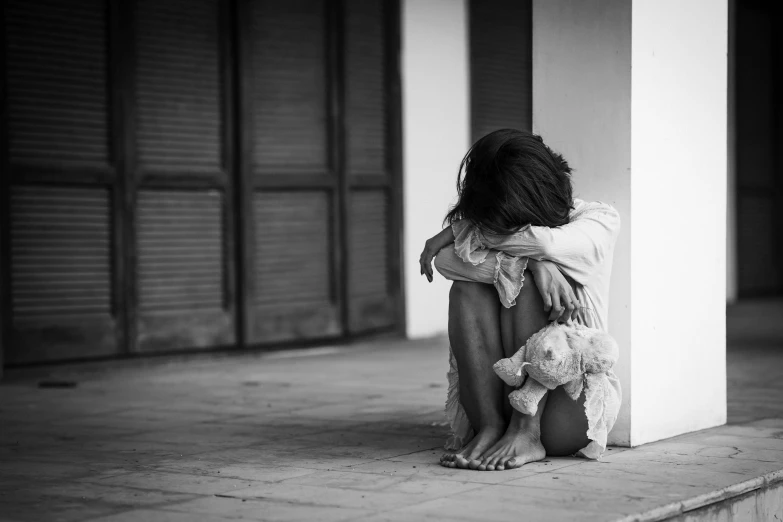 a person sitting on the ground with a teddy bear, a black and white photo, pexels, hurufiyya, woman crying, violence, children, 15081959 21121991 01012000 4k