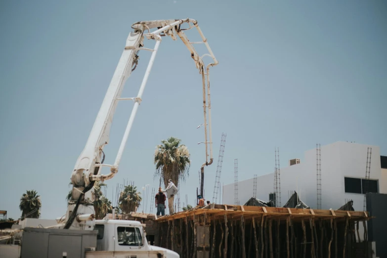 a white truck parked next to a building under construction, a portrait, unsplash, palm springs, pouring, profile image