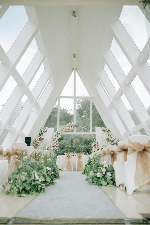 a room filled with lots of white tables and chairs, arsitektur nusantara, ribbon chapel, bouquets, greenhouse