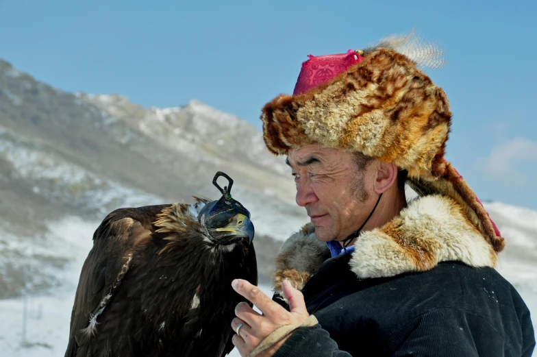 a man that is holding a bird in his hand, by Dietmar Damerau, pexels contest winner, hurufiyya, kazakh empress, avatar image, breitling, 2019 trending photo