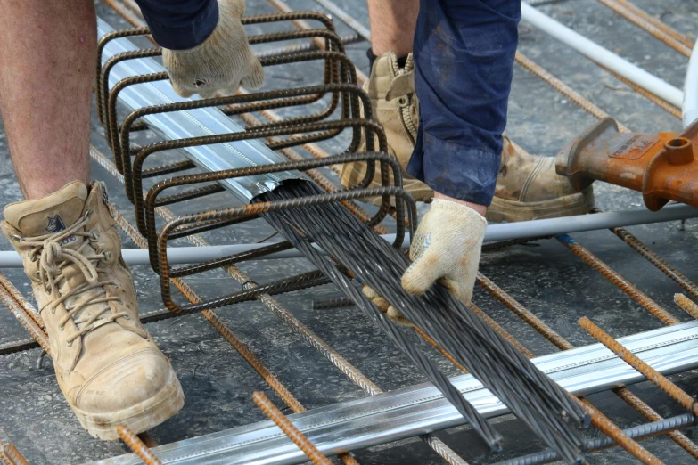 a man standing on top of a metal grate, plasticien, steel studs, concrete, thick wires, thumbnail