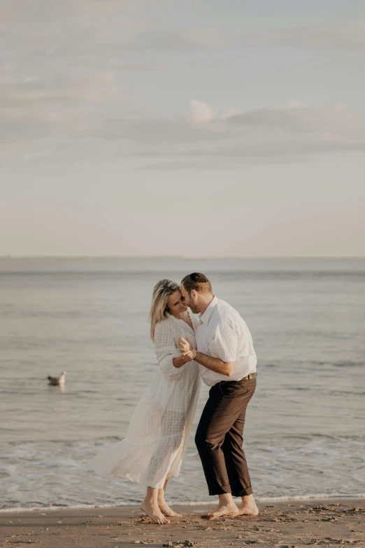 a man and woman standing on a beach next to the ocean, dancing elegantly over you, 2019 trending photo, gif, 15081959 21121991 01012000 4k