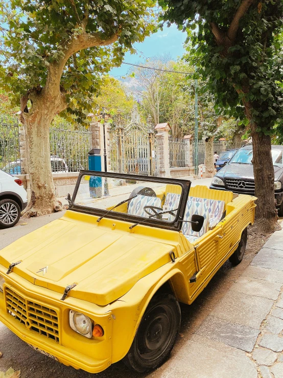 a yellow car parked on the side of the road, french village exterior, 🦩🪐🐞👩🏻🦳, open top, palermo city street