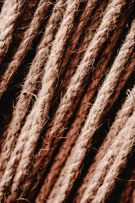 a close up of a rope of yarn, an album cover, by Adam Marczyński, trending on pexels, brown tones, carbon fibers, super detailed image, concerned