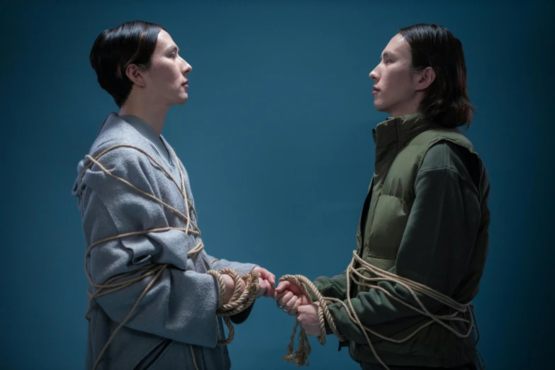 a couple of women standing next to each other, an album cover, inspired by Mathieu Le Nain, unsplash, conceptual art, with wires and bandages, inuit, film still of gal gadot, shibari