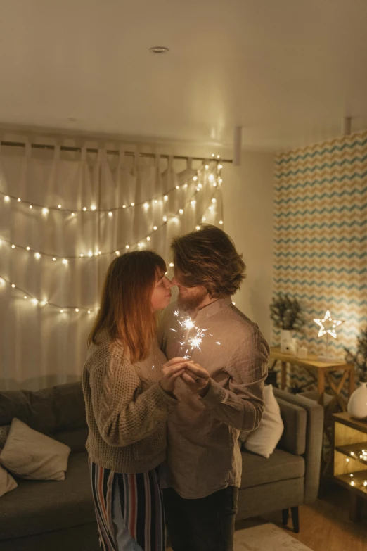 a man and woman standing next to each other in a living room, pexels, light and space, fairy lights, kiss, holiday, 8 k )