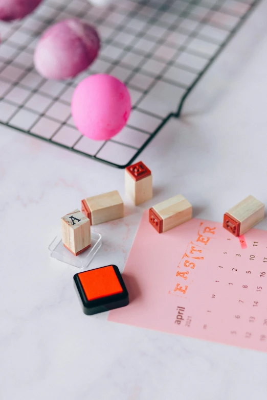 a bunch of rubber stamps sitting on top of a table, by Julia Pishtar, trending on pexels, pink and orange, easter, female calendar, square