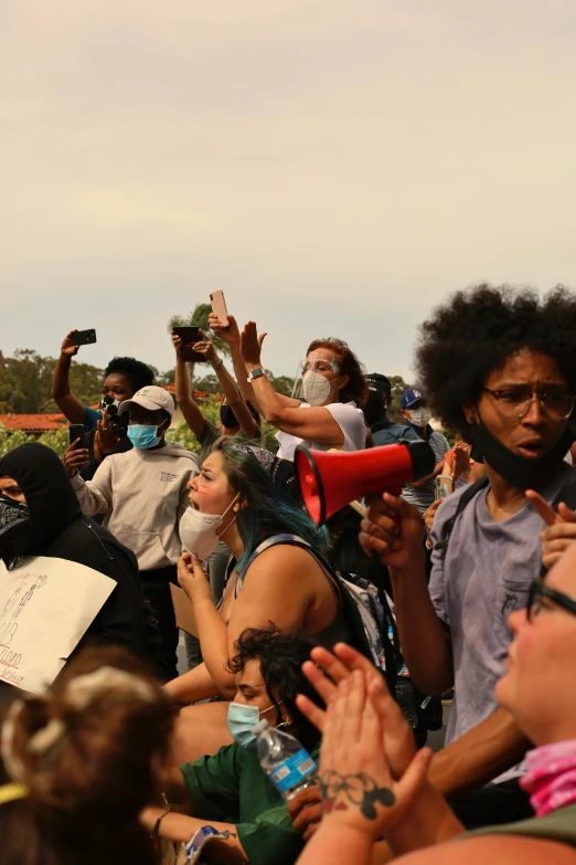 a crowd of people standing next to each other, happening, protest, one black, shot from roofline, masks