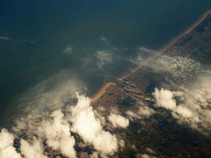 an aerial view of a large body of water, a picture, unsplash, land art, cotton clouds, dredged seabed, sri lankan landscape, low dutch angle