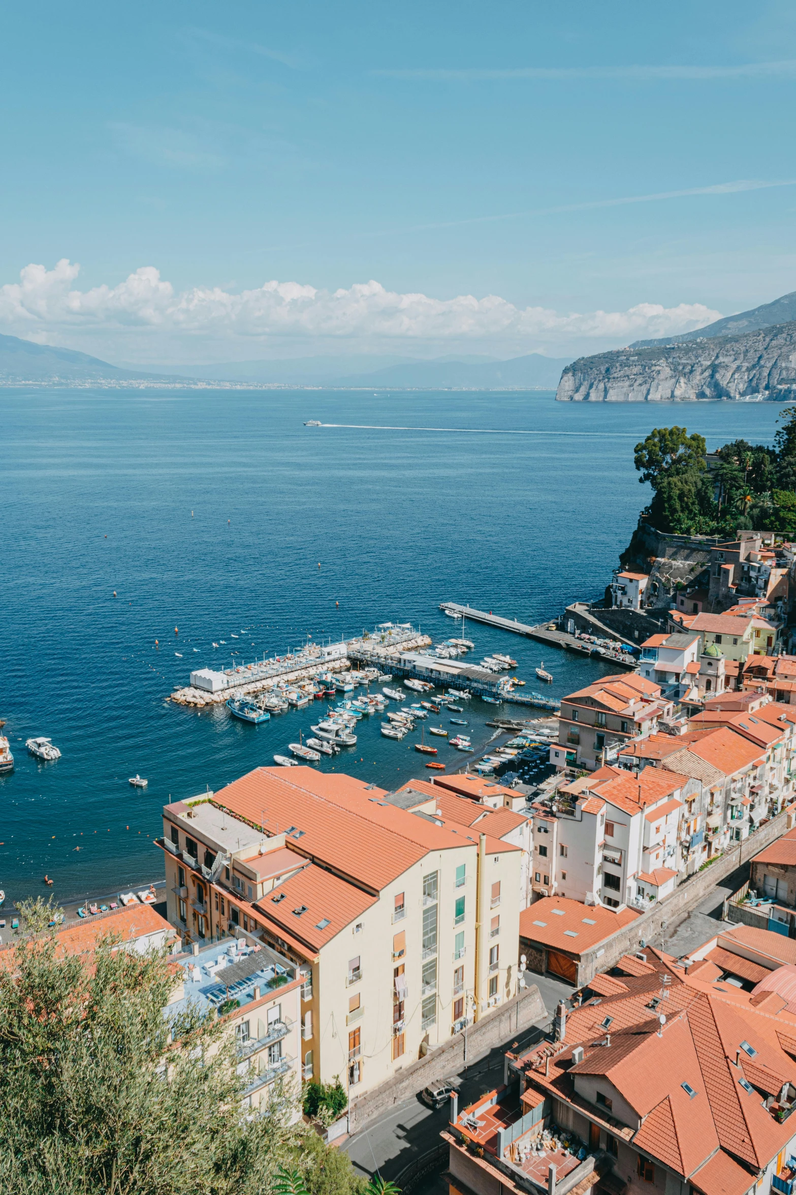 a view of a town from the top of a hill, inspired by Carlo Randanini, pexels contest winner, renaissance, coastal cliffs, square, slim aarons, harbour in background