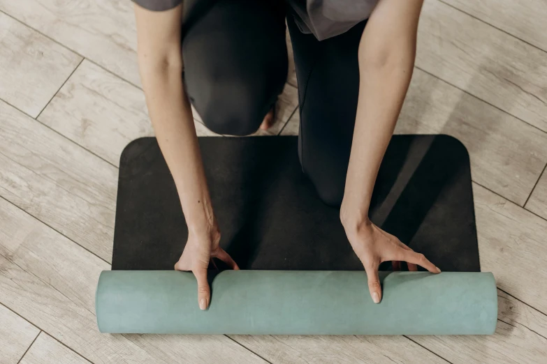 a close up of a person on a yoga mat, private press, black and teal paper, eucalyptus, standing pose, ashy