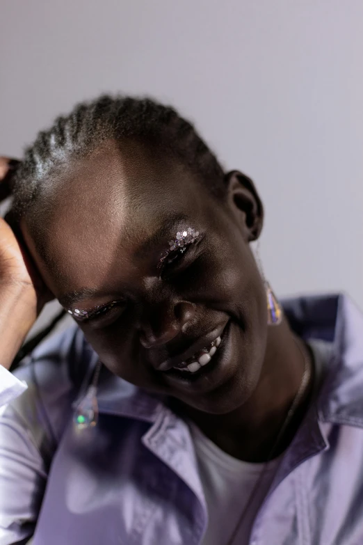 a close up of a person holding a cell phone, an album cover, by Charly Amani, hurufiyya, adut akech, head bent back in laughter, relaxed eyebrows, pearlescent skin