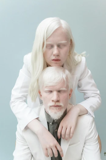 a woman sitting on top of a man in a suit, an album cover, inspired by Louisa Matthíasdóttir, tumblr, portrait of albino mystic, whiteout eyes, trending on dezeen, biological photo