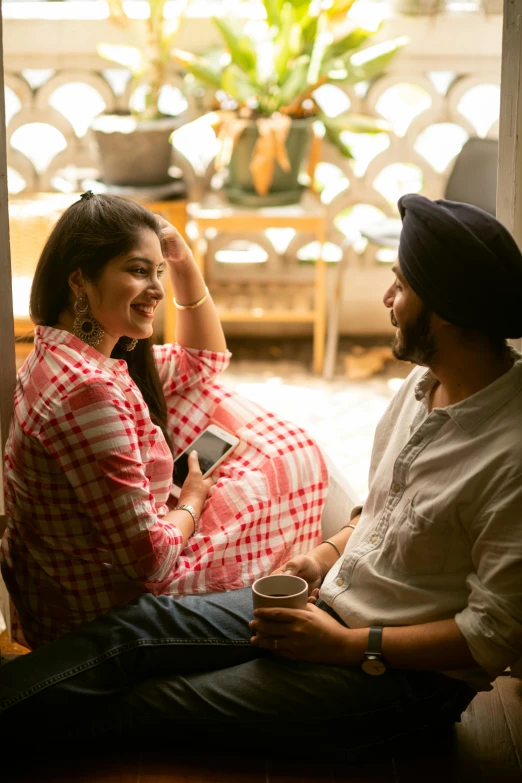 a man and a woman sitting next to each other, by Manjit Bawa, pexels contest winner, happening, flirting smiling, at home, promotional image, indian