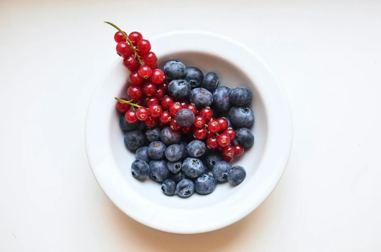 a white bowl filled with blueberries and red currans, pexels, bowl filled with food, grey, raspberry, small