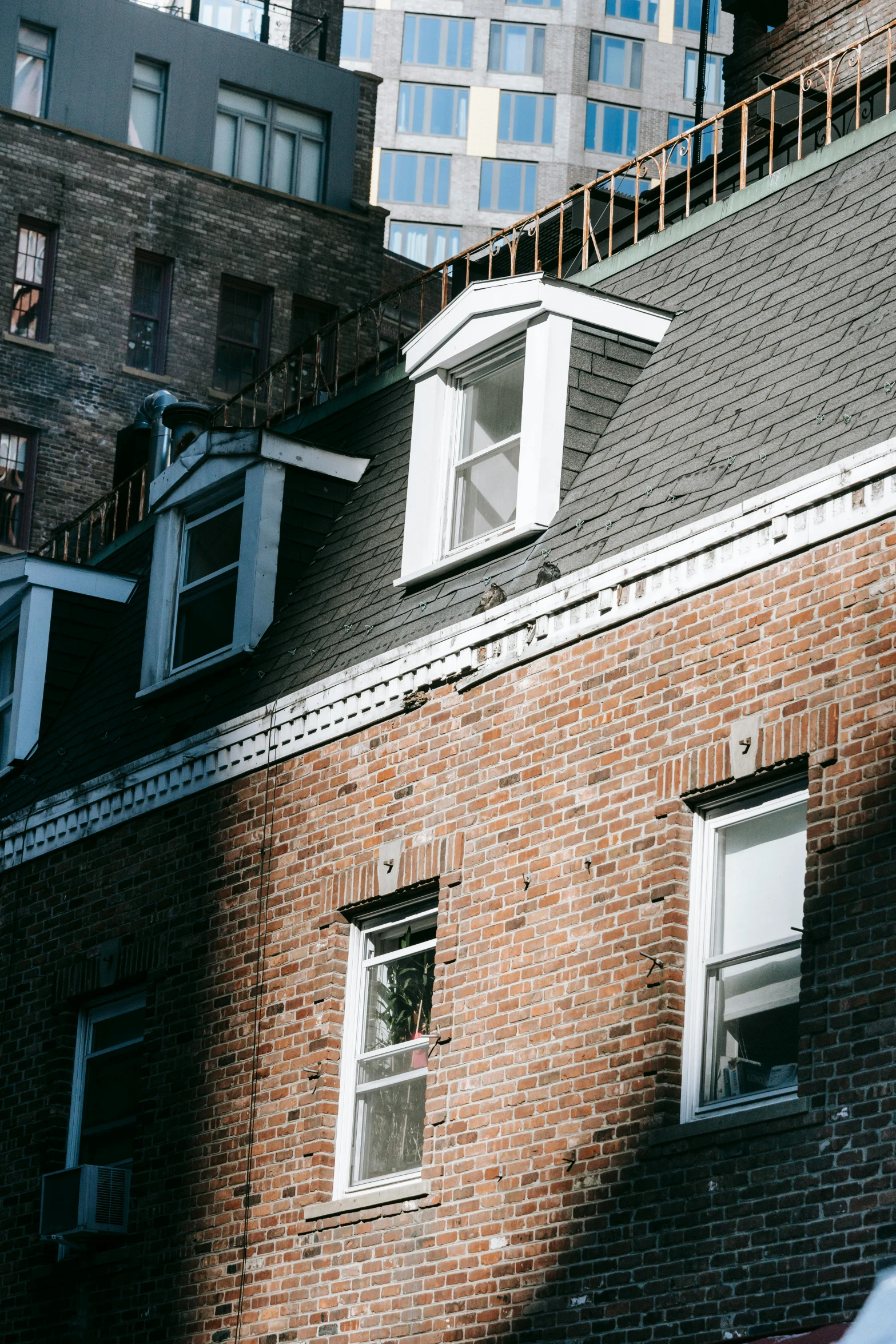 a red fire hydrant sitting on top of a brick building, by Carey Morris, trending on unsplash, modernism, cramped new york apartment, simple gable roofs, windows and walls :5, white houses