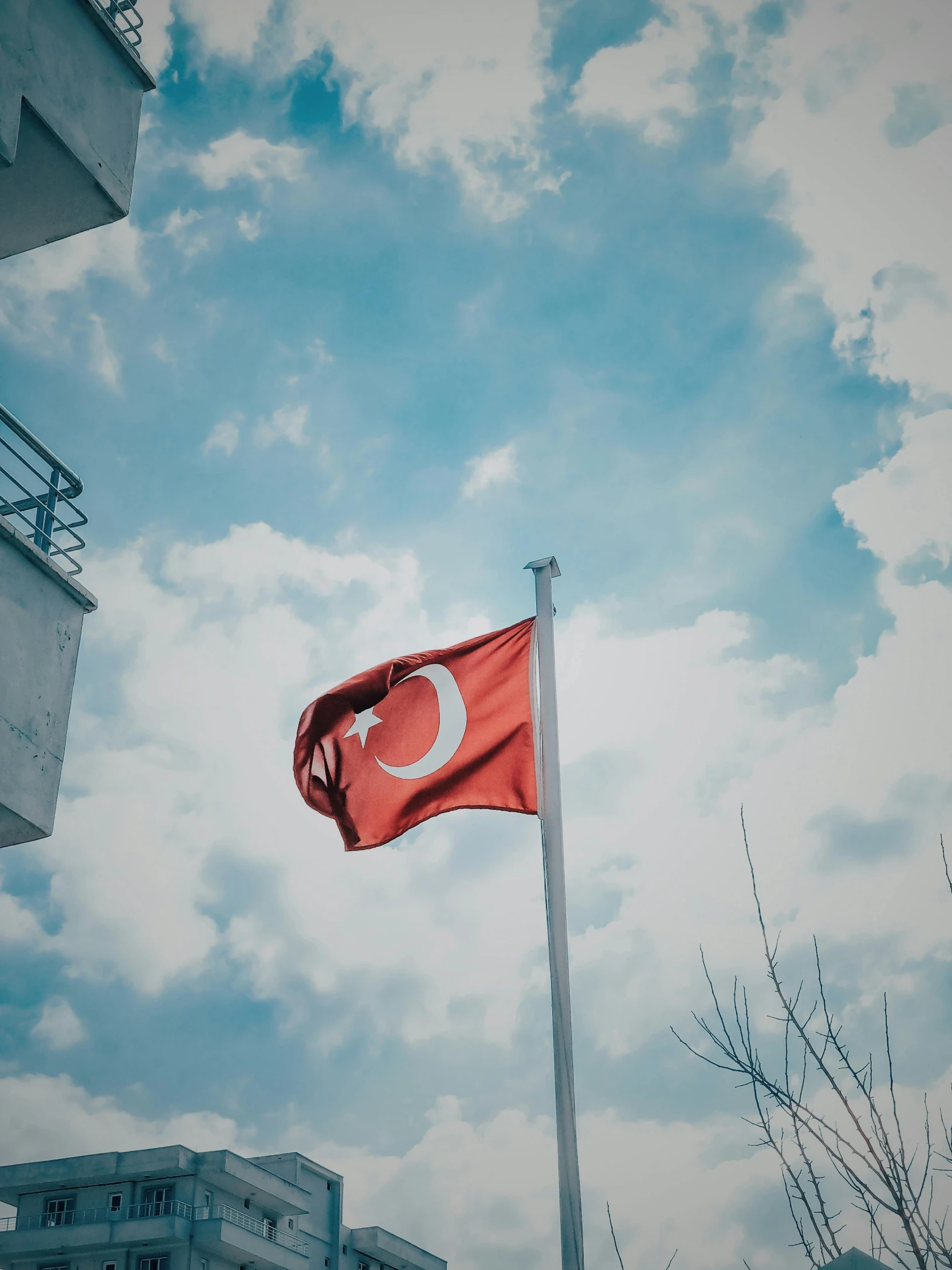 a turkish flag flying in front of a building, pexels contest winner, hurufiyya, ☁🌪🌙👩🏾, square, student, chemistry