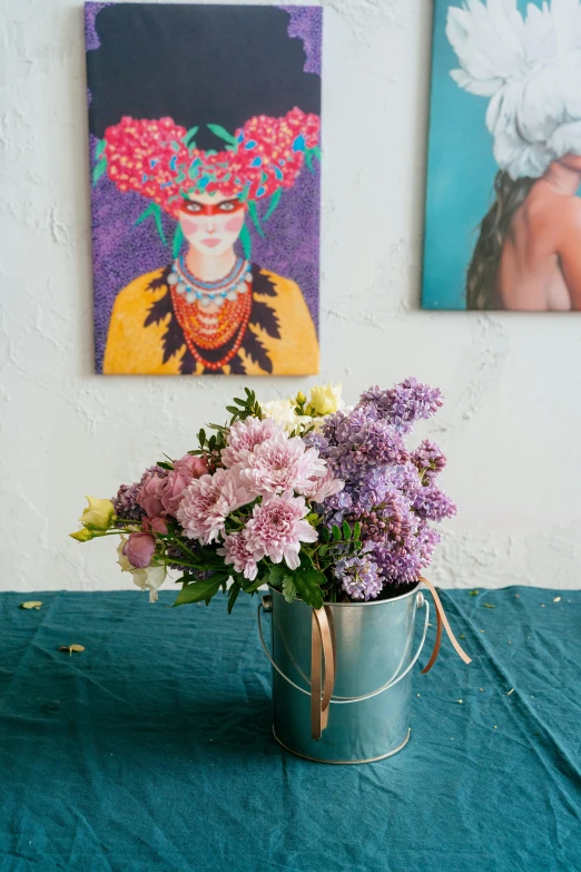 a vase of flowers sitting on top of a table, inspired by Kahlo, lilac, midsommar color theme, dahlias, in a gallery setting