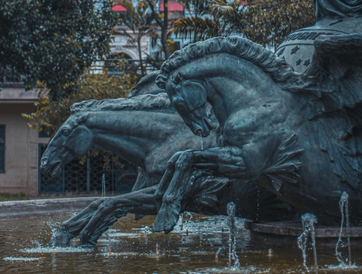a statue of a man riding on the back of a horse, a statue, by Alejandro Obregón, pexels contest winner, art nouveau, fountain of water, horse laying down, wellington, shot with sony alpha