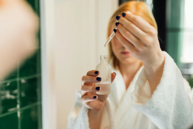 a woman brushing her teeth in front of a mirror, by Julia Pishtar, pexels contest winner, renaissance, droplets flow down the bottle, surgical iv drip, jenna barton, manicured