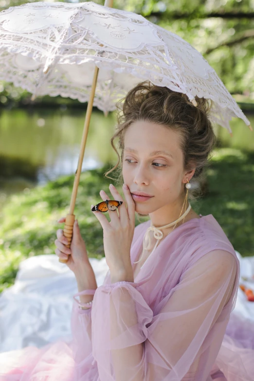 a woman in a pink dress holding an umbrella, a portrait, inspired by Konstantin Somov, unsplash, butterfly jewelry, film still from the movie, eating outside, elizabeth olsen