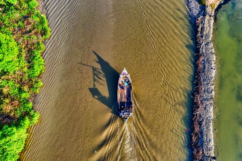 a boat traveling down a river next to a forest, by Jan Tengnagel, pexels contest winner, visual art, hot sun from above, vietnam, thumbnail, bird\'s eye view