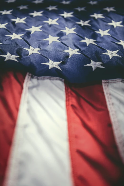 an american flag laying on top of a bed, by Daniel Taylor, trending on unsplash, dynamic closeup, multiple stories, closeup 4k, digital image