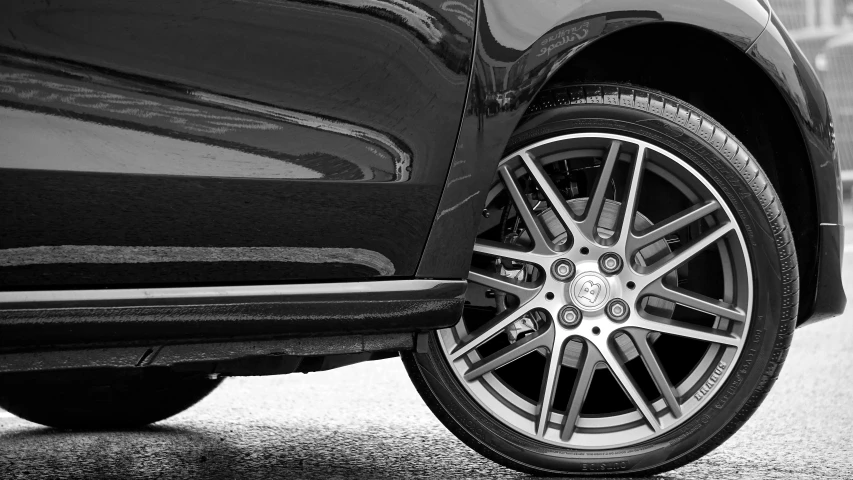 a close up of a car tire on a city street, by Niko Henrichon, super detailing, monocolor, black rims, thumbnail