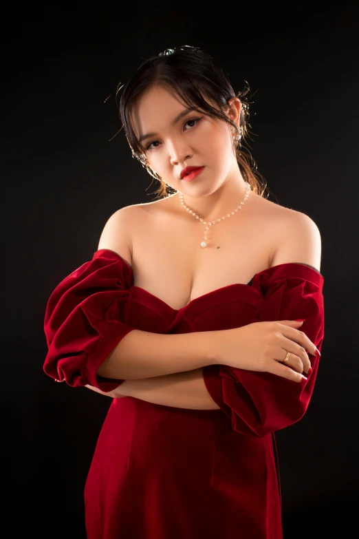 a woman in a red dress posing for a picture, an album cover, inspired by Feng Zhu, unsplash, photorealism, cleavage, studio!! portrait lighting, vietnamese woman, thick neck