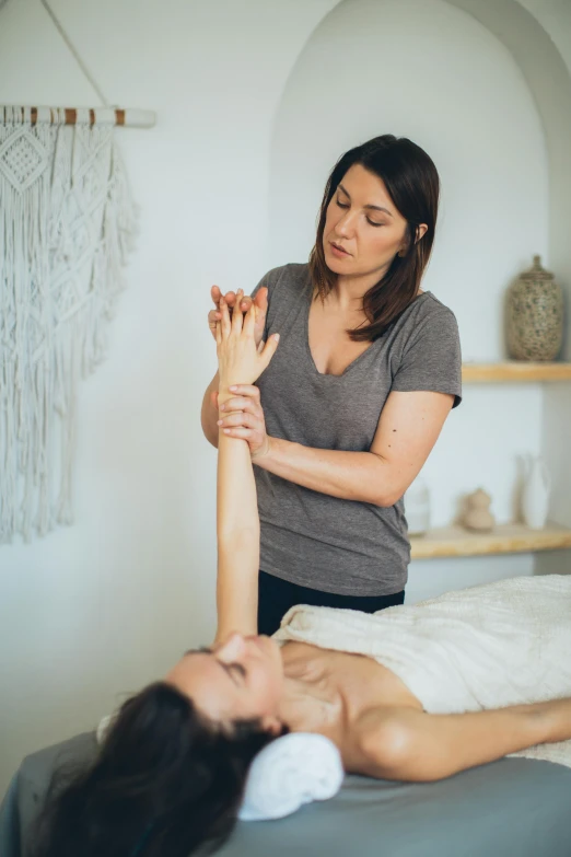 a woman getting a massage in a room, jen atkin, raising an arm, organic detail, square