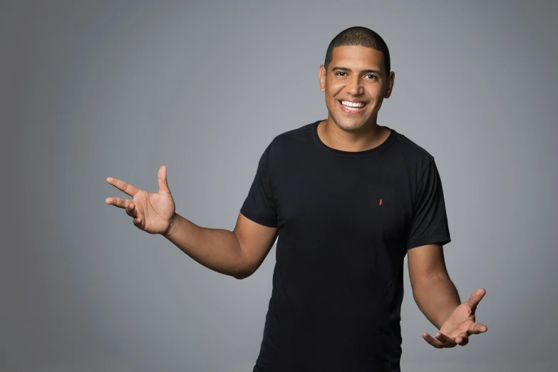 a man in a black shirt posing for a picture, inspired by Ismail Gulgee, pexels, les nabis, standup comedian, wearing a black tshirt, manuka, jeremy lipkin