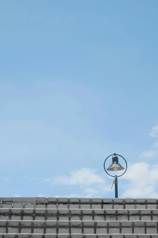 a street light on top of a brick wall, by Peter Churcher, postminimalism, sky blue, circular, square, 2 4 mm iso 8 0 0