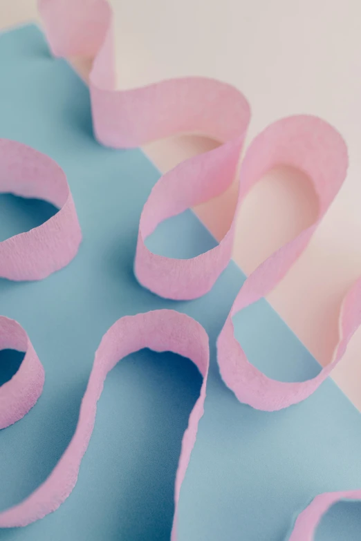 a pair of scissors sitting on top of a piece of paper, made of cotton candy, intricate pasta waves, detail shot, detailed product image