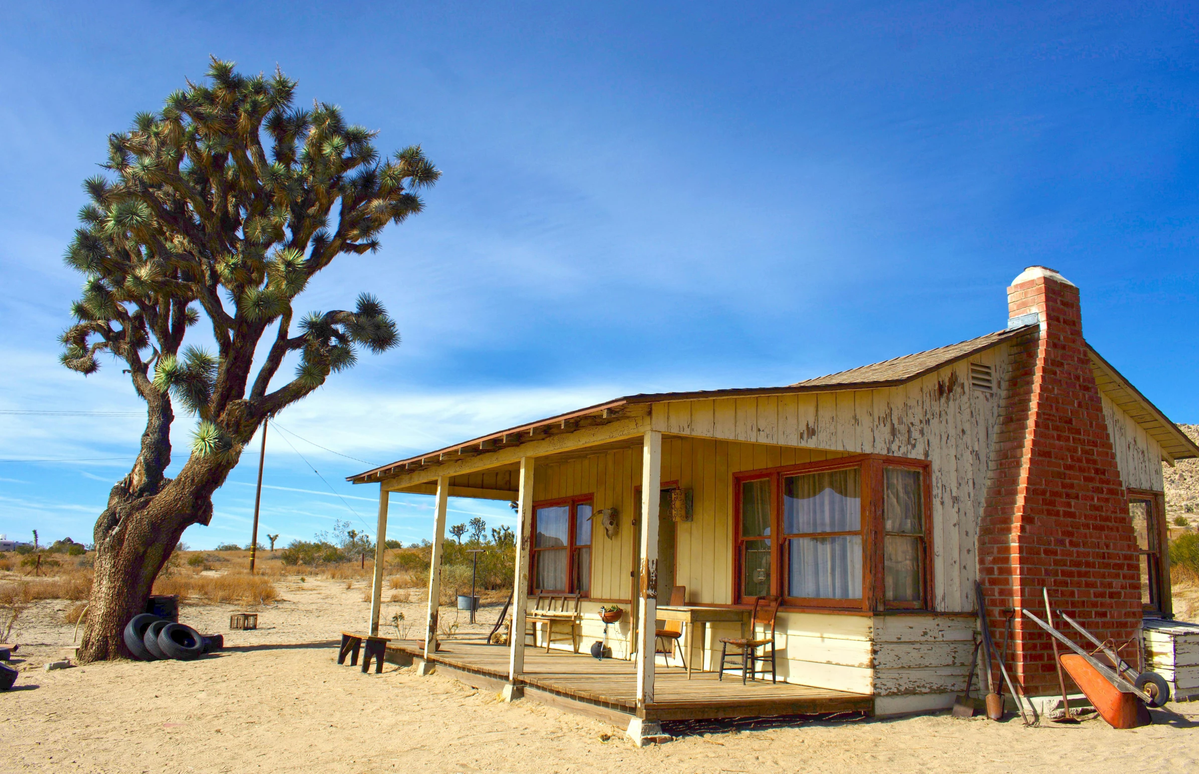 a small house in the middle of the desert, by Gwen Barnard, pexels contest winner, renaissance, saloon exterior, square, with a front porch, western film