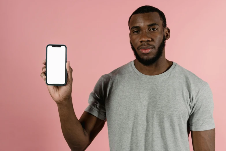 a man holding up a smart phone with a blank screen, pexels contest winner, figuration libre, pastel pink skin tone, black man, portrait of tall, one black