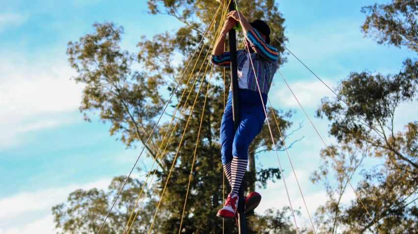 a man flying through the air on top of a rope, by Gwen Barnard, unsplash, happening, sydney park, teepee, on stilts, panoramic view of girl