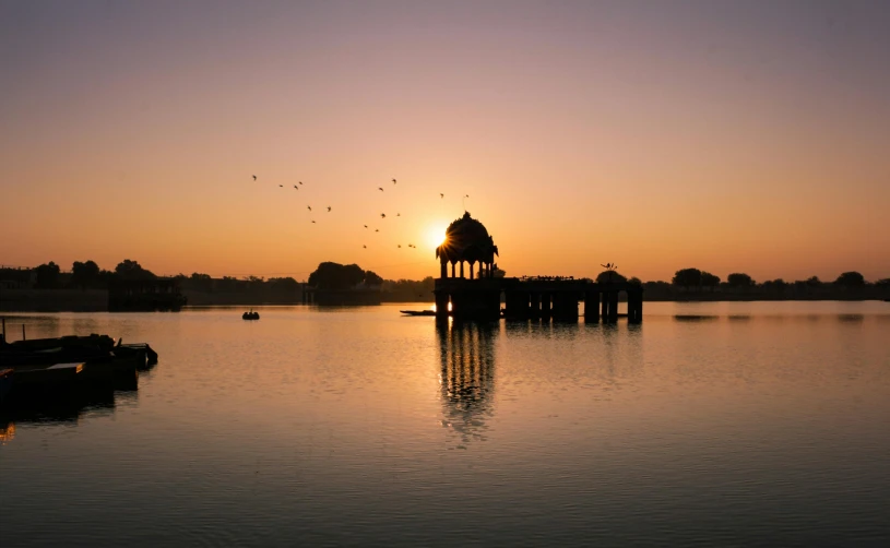 the sun is setting over a body of water, by Saurabh Jethani, pexels contest winner, hurufiyya, water temple, lagoon, istock, top