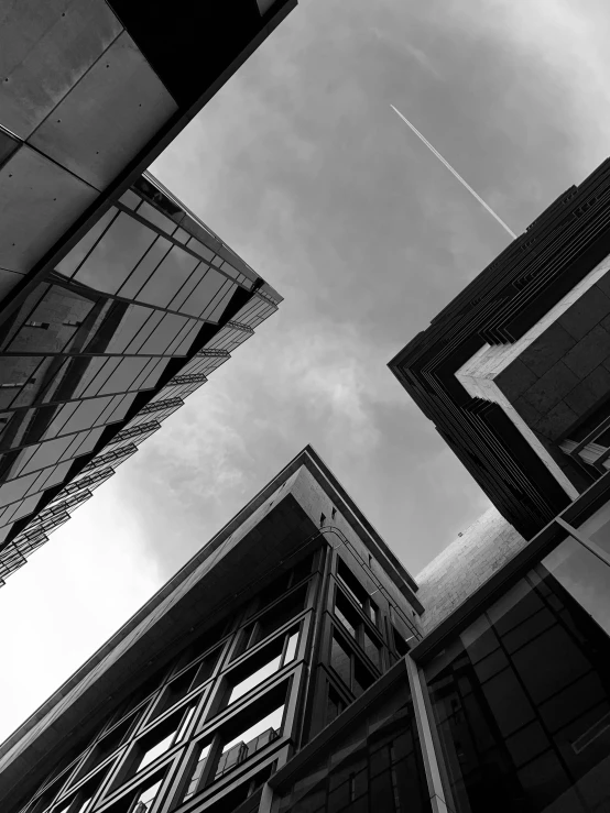 a black and white photo of tall buildings, unsplash, dynamic perspective and angle, sharp and blocky shapes, low angle!!!!