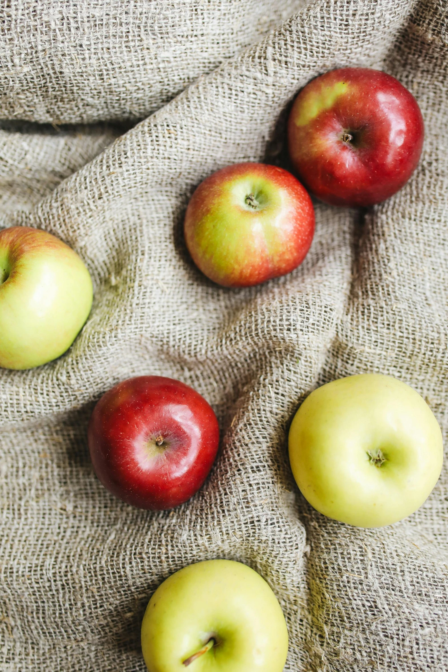 a bunch of apples sitting on top of a cloth, promo photo, various colors, no crop, panel