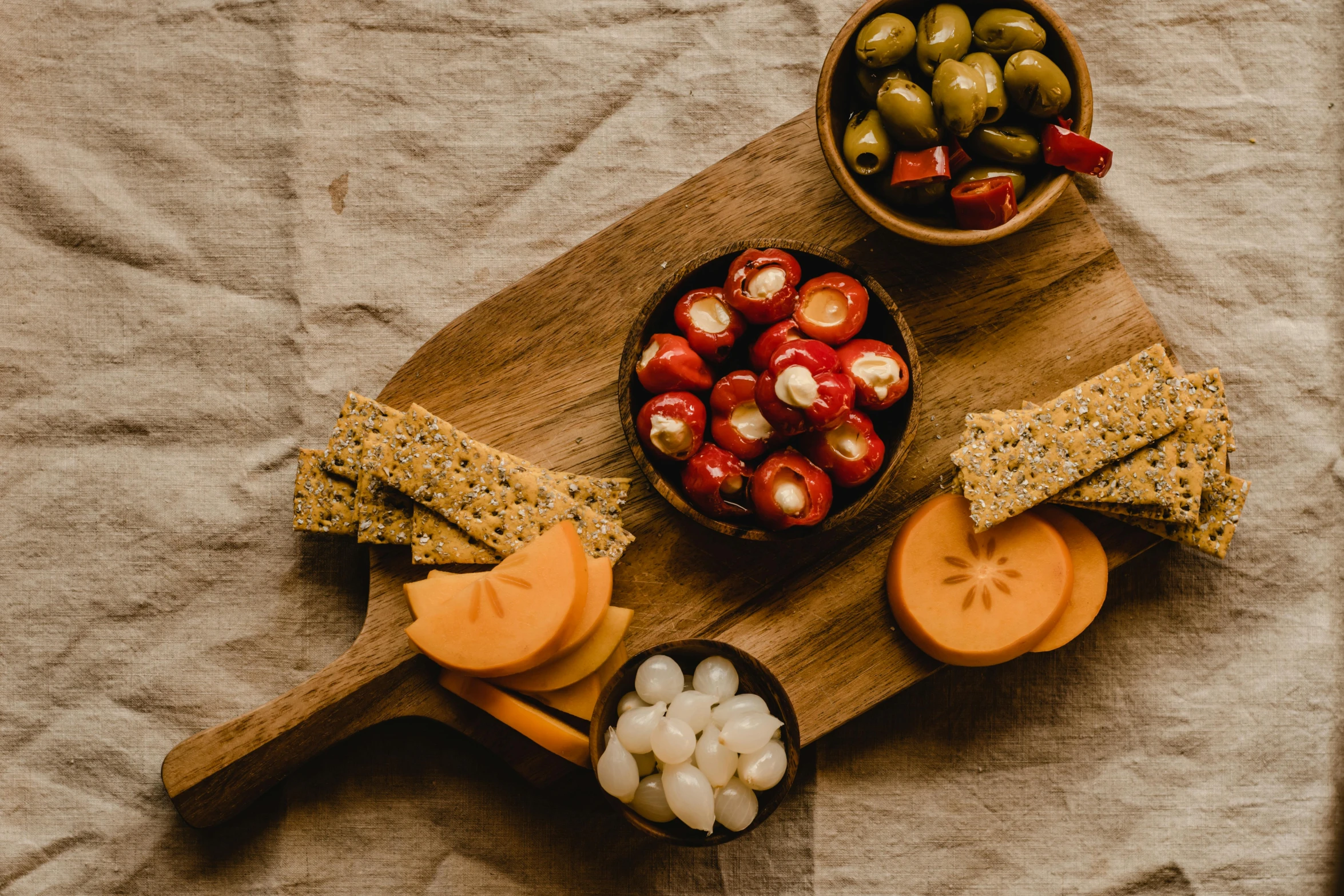 a wooden cutting board topped with cheese and olives, by Carey Morris, pexels, red palette, having a snack, background image, full body image