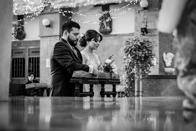 a black and white photo of a bride and groom, by Nándor Katona, on the altar, zigor samaniego style, candid photo, 🕹️ 😎 🔫 🤖 🚬