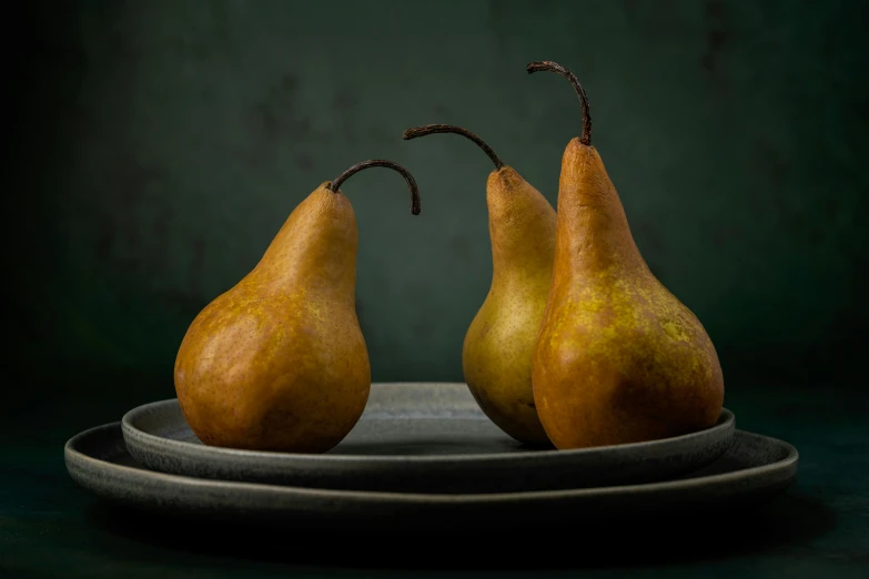 two pears sitting on a plate on a table, a still life, inspired by William Michael Harnett, unsplash, medium format, award winning photograph, looking to the side, gourds